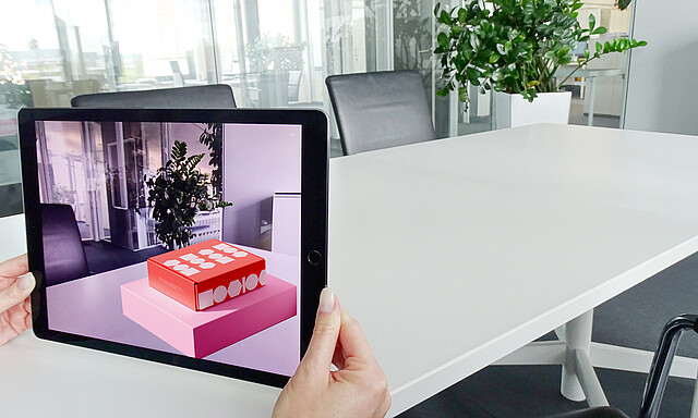 A tablet shows packaging virtually.