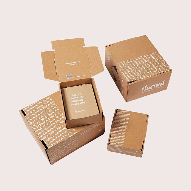 Four cardboard boxes with white print.